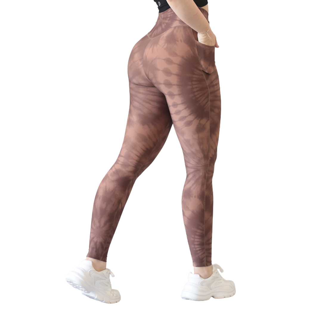 Leggings deportivos supplex para mujer, efecto básico con cintura alta, bolsillos laterales y textil lycra transpirable con acabado liso tie day. Color marrón | Adriana Olimpo