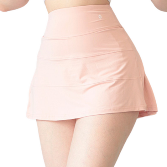 Falda short deportiva para mujer, cintura alta con acabado liso. Color rosa limonada | Adriana Olimpo